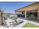 Spacious covered patio featuring stylish lounge chairs and ample seating for outdoor entertaining at 35486 N Morello Dr, Queen Creek, AZ 85140