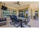 Covered patio area with outdoor dining set and a view to the backyard and interiors at 35486 N Morello Dr, Queen Creek, AZ 85140