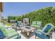 Outdoor living space with comfortable seating and fire pit surrounded by privacy hedges and a hot tub at 35486 N Morello Dr, Queen Creek, AZ 85140