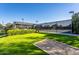 Perfect tennis court setting with covered area, seating and lush green landscape at 35486 N Morello Dr, Queen Creek, AZ 85140