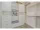 This walk-in closet offers custom shelving, drawers, and hanging rods for optimal organization and storage at 35486 N Morello Dr, Queen Creek, AZ 85140