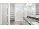 Bright bathroom with double sinks, granite counters, and walk-in shower at 35941 W San Ildefanso Ave, Maricopa, AZ 85138