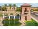 Elegant community entrance with stone tower, water feature, and lush landscaping welcomes residents and guests alike at 35941 W San Ildefanso Ave, Maricopa, AZ 85138