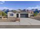 Charming single-story home with desert landscaping and a two car garage against a backdrop of mountains at 35941 W San Ildefanso Ave, Maricopa, AZ 85138