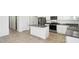 Kitchen boasts an island with granite countertops, stainless steel appliances, and tile flooring at 35941 W San Ildefanso Ave, Maricopa, AZ 85138