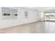 Bright, open-concept living room with tile floors, and multiple windows allowing for great natural light at 35941 W San Ildefanso Ave, Maricopa, AZ 85138