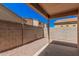 Low maintenance backyard with gravel, block fence, and covered patio area at 3719 W Carson Rd, Phoenix, AZ 85041