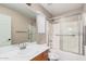 Bathroom with wood vanity, tub with shower, and large mirror at 3719 W Carson Rd, Phoenix, AZ 85041