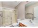 Well-lit bathroom with a glass-enclosed shower and vanity with a sink at 3719 W Carson Rd, Phoenix, AZ 85041