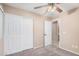 Cozy bedroom features neutral walls, plush carpeting, and a ceiling fan for comfort at 3719 W Carson Rd, Phoenix, AZ 85041