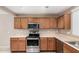 Modern kitchen with stainless steel appliances and wood cabinets at 3719 W Carson Rd, Phoenix, AZ 85041