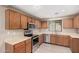 Well-lit kitchen with wood cabinets, stainless steel appliances and light countertops at 3719 W Carson Rd, Phoenix, AZ 85041