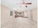 Spacious, bright living room featuring tile floors, a ceiling fan, and an open layout to the kitchen at 3719 W Carson Rd, Phoenix, AZ 85041