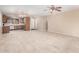 Spacious, bright living room featuring tile floors, a ceiling fan, and an open layout to the kitchen at 3719 W Carson Rd, Phoenix, AZ 85041