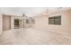 Bright living room featuring neutral walls, tile floors, a sliding glass door, and an open layout to the kitchen at 3719 W Carson Rd, Phoenix, AZ 85041