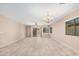 Bright living room featuring neutral walls, tile floors, and a sliding glass door at 3719 W Carson Rd, Phoenix, AZ 85041