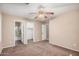 Carpeted bedroom with doorways to bathroom and closet, fan, neutral color paint at 3719 W Carson Rd, Phoenix, AZ 85041