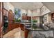 Gourmet kitchen boasts dark wood cabinets, granite countertops, and modern stainless-steel appliances at 40635 N 109Th Pl # 3 & 5, Scottsdale, AZ 85262