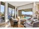 Bright living room with large windows overlooking the outdoor pool and patio area at 40635 N 109Th Pl # 3 & 5, Scottsdale, AZ 85262