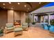 Comfortable patio seating adjacent to the pool with desert views and a cozy fireplace at 40635 N 109Th Pl # 3 & 5, Scottsdale, AZ 85262