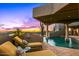Relaxing poolside view with lounge chairs, sunset, and covered patio area at 40635 N 109Th Pl # 3 & 5, Scottsdale, AZ 85262