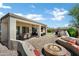 Outdoor oasis with a fire pit and kitchen at 41215 N Lytham Ct, Phoenix, AZ 85086