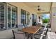 Covered patio with ceiling fan and an outdoor dining space perfect for entertaining at 41215 N Lytham Ct, Phoenix, AZ 85086