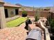 Resort style backyard featuring a putting green, built-in grill, and desert landscaping at 41215 N Lytham Ct, Phoenix, AZ 85086
