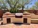 Outdoor kitchen with built-in grill on tile patio with desert landscaping at 41215 N Lytham Ct, Phoenix, AZ 85086
