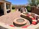 Backyard patio with built-in seating area, a fire pit, and desert views at 41215 N Lytham Ct, Phoenix, AZ 85086