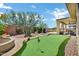 This backyard boasts desert landscaping, custom putting green and a built in grilling and entertaining space at 41215 N Lytham Ct, Phoenix, AZ 85086