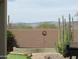 Backyard with desert landscaping, artificial turf, and views of mountains at 41215 N Lytham Ct, Phoenix, AZ 85086