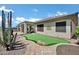 This backyard features a custom putting green, desert landscaping and a covered patio for outdoor living at 41215 N Lytham Ct, Phoenix, AZ 85086