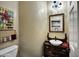Powder room featuring a vanity with vessel sink, decorative mirror, and a stylish chandelier at 41215 N Lytham Ct, Phoenix, AZ 85086
