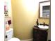 A clean, half-bathroom with a toilet and decorative vanity with a vessel sink at 41215 N Lytham Ct, Phoenix, AZ 85086