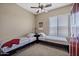 Shared bedroom with two twin beds, a ceiling fan, window, carpet, and closets with sliding doors at 41215 N Lytham Ct, Phoenix, AZ 85086