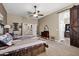 Spacious bedroom with carpeted floors, ceiling fan, and doorway barn door at 41215 N Lytham Ct, Phoenix, AZ 85086