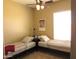 Bedroom with two beds, a shared nightstand, and a large window, creating a comfortable space at 41215 N Lytham Ct, Phoenix, AZ 85086
