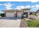 Inviting single-story home with a three-car garage and desert landscaping in front yard at 41215 N Lytham Ct, Phoenix, AZ 85086