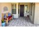 Charming covered front porch with decorative bench and tiled flooring at 41215 N Lytham Ct, Phoenix, AZ 85086