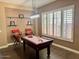 Entertain in this game room featuring a pool table, light fixture and plantation shutters at 41215 N Lytham Ct, Phoenix, AZ 85086