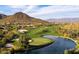 Scenic aerial view of the golf course with lush green fairways and a tranquil lake in foreground at 41215 N Lytham Ct, Phoenix, AZ 85086