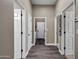 Hallway with multiple doors, leading to different rooms within the home. One door leads to the laundry room at 41215 N Lytham Ct, Phoenix, AZ 85086