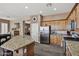 Open kitchen with stainless steel appliances, granite countertops, and a center island with a sink at 41215 N Lytham Ct, Phoenix, AZ 85086