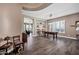 Spacious living area with dark floors and plantation shutters, plus a billiard table at 41215 N Lytham Ct, Phoenix, AZ 85086