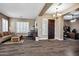 Inviting living room featuring wood floors, plantation shutters, and a modern light fixture at 41215 N Lytham Ct, Phoenix, AZ 85086