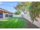 Spacious backyard with lush green grass and a covered patio area at 4525 N 66Th St # 95, Scottsdale, AZ 85251