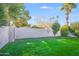 Backyard with well-maintained lawn, mature trees and block fence at 4525 N 66Th St # 95, Scottsdale, AZ 85251