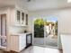 Dining area featuring white cabinetry, wine fridge, and outdoor access at 4525 N 66Th St # 95, Scottsdale, AZ 85251
