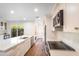Bright kitchen features white cabinets, stainless steel appliances, stone countertops, and a gold faucet at 4525 N 66Th St # 95, Scottsdale, AZ 85251